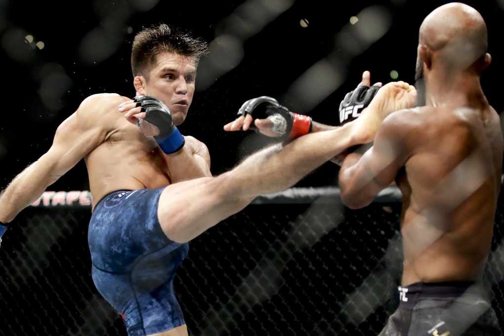 Henry Cejudo kicks Demetrious Johnson during their flyweight title bout at UFC 227. Photo: AP