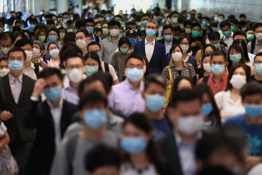 A crowd of masked morning commuters walk through Central MTR station on Monday. Photo: May Tse