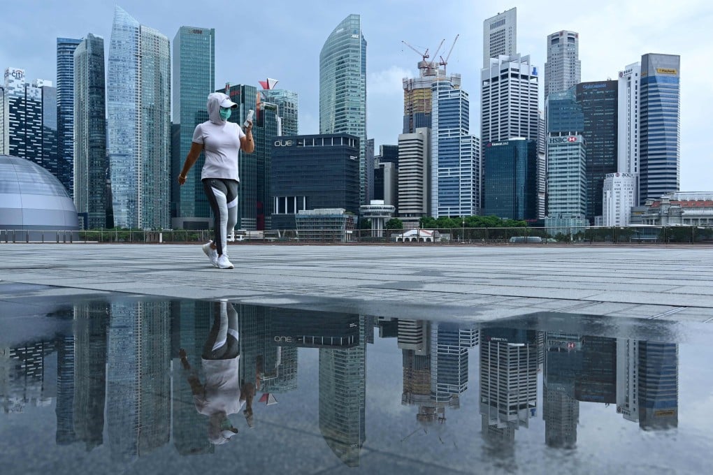 A woman, wearing a face mask as a preventive measure against the spread of the coronavirus, walks along the promenade at Marina Bay in Singapore on May 4. Photo: AFP