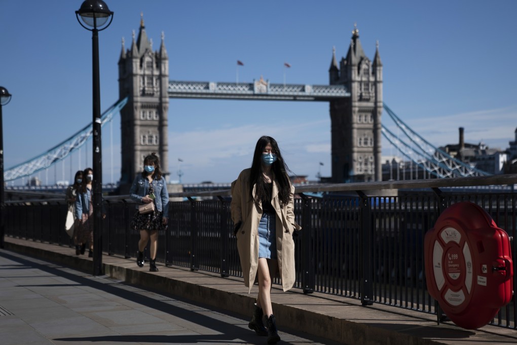 People walk past Tower Bridge in central London. Photo: EPA-EFE
