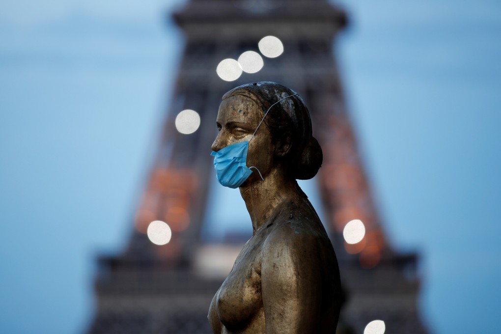 Paris’ Golden Statue, near the Eiffel Tower, is adorned with a surgical mask, in acknowledgement of an outbreak that may have reached France in December. Photo: Reuters