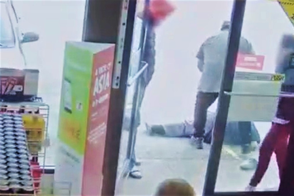 The suspect in a racist attack on an elderly Asian man stands over his victim outside a Vancouver convenience store on March 13, in a video released by Vancouver police. Photo: Vancouver Police Department