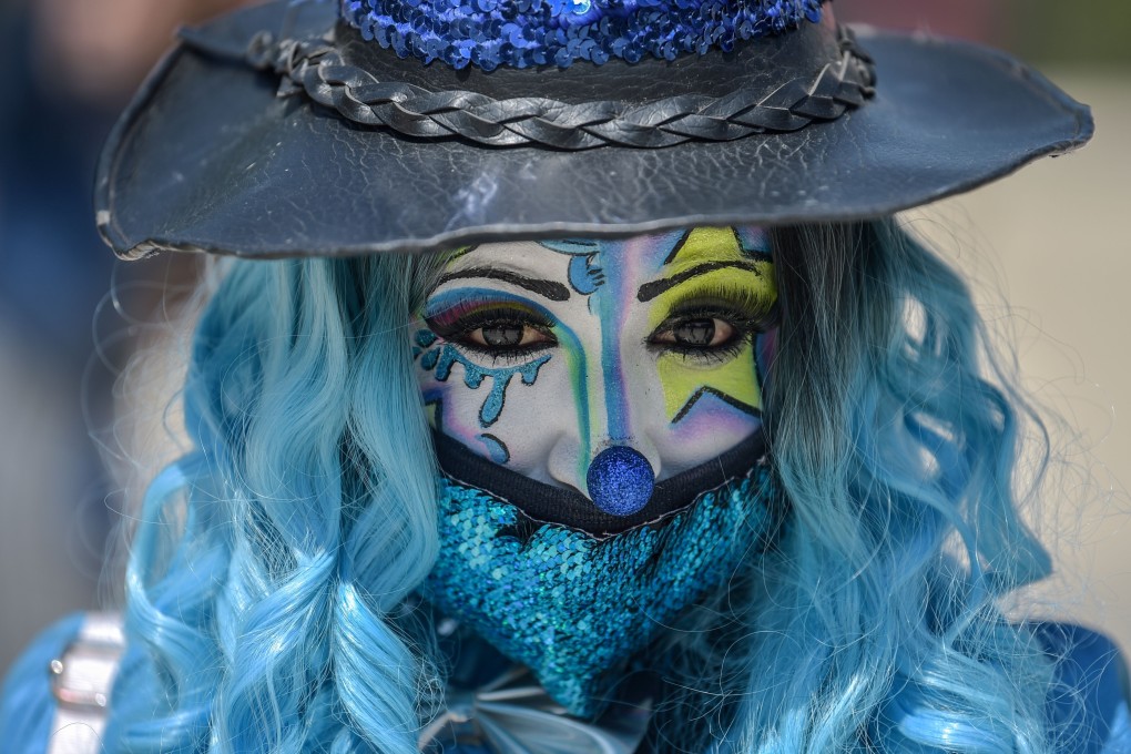 A clown wears a face mask during a protest in Mexico City in April to demand government aid, as they have been unable to work on the streets for a month. Photo: AFP