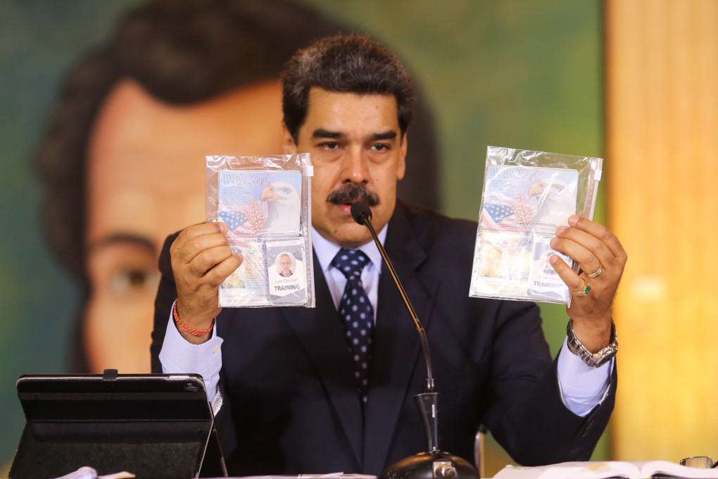 Venezuela’s President Nicolas Maduro shows what Venezuelan authorities claim are identification documents of US citizens Airan Berry and Luke Denman during an online press conference in Caracas on Wednesday. Photo: Miraflores Palace presidential press office via AP