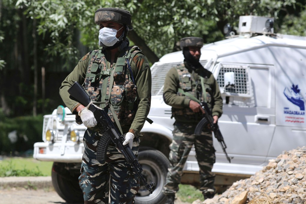 Indian paramilitary soldiers stand guard near the site where a gunfight took place at Beighpora village in south Kashmir's Pulwama district, near Srinagar, in which a top militant, Riyaz Naikoo, and a close aide were killed. Photo: EPA-EFE