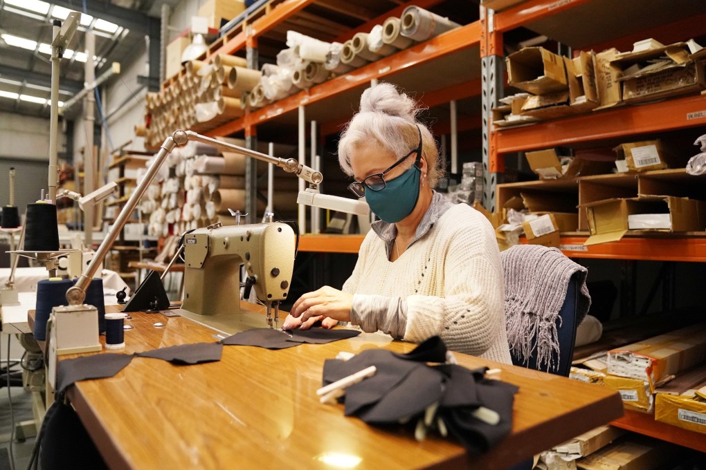 A worker uses a sewing machine to sew face masks at a Carrum Downs factory in Melbourne. Photo: EPA-EFE