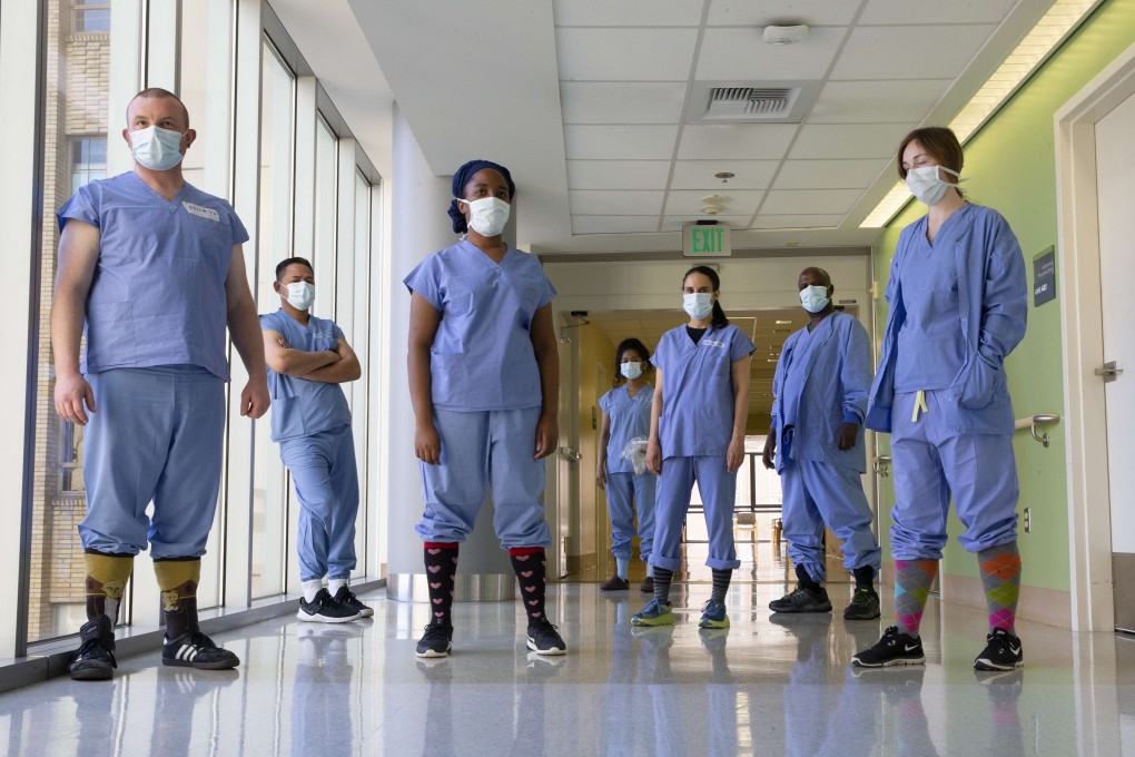 Health care workers in the acute care Covid-19 unit at a Seattle hospital show off their socks. Medical staff began tucking the pant legs of their hospital scrubs in socks as a way to prevent infection from spreading but it has now become a coping strategy. Photo: AFP