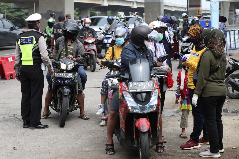 Indonesian police and government officers question motorists at a police checkpoint on May 1. Photo: AP