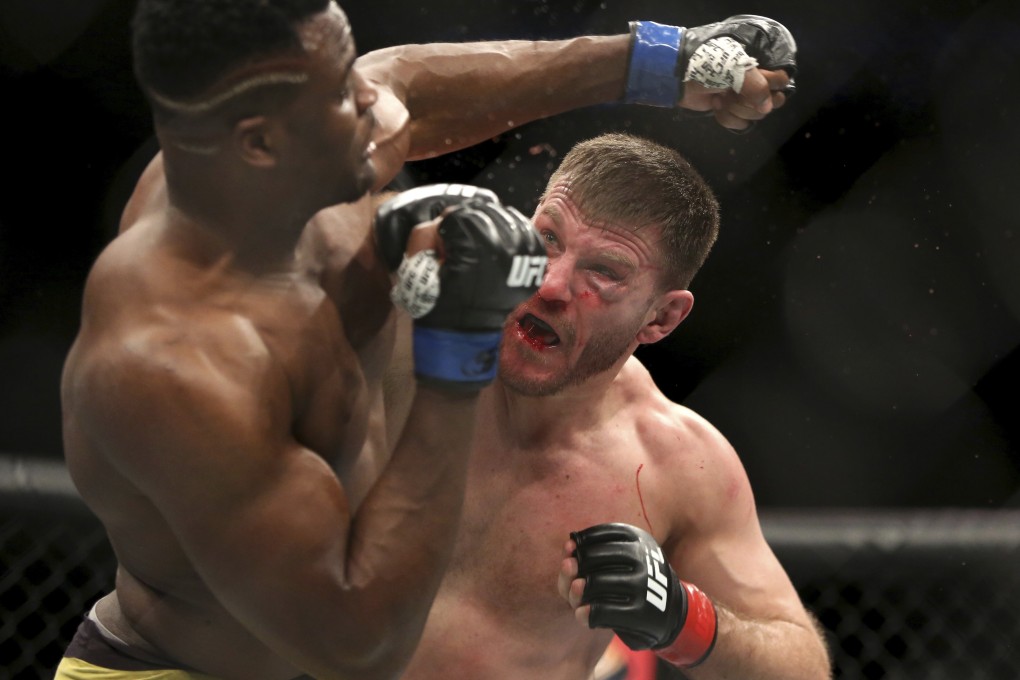 Stipe Miocic lands a right hand against Francis Ngannou during their heavyweight championship bout at UFC 220 in Boston. Photo: AP