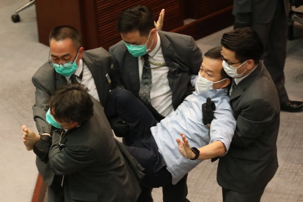 Pan-democrat lawmaker Raymond Chan, pictured being removed from Legco’s chamber, is among those to make allegations relating to Friday’s mayhem. Photo: Dickson Lee