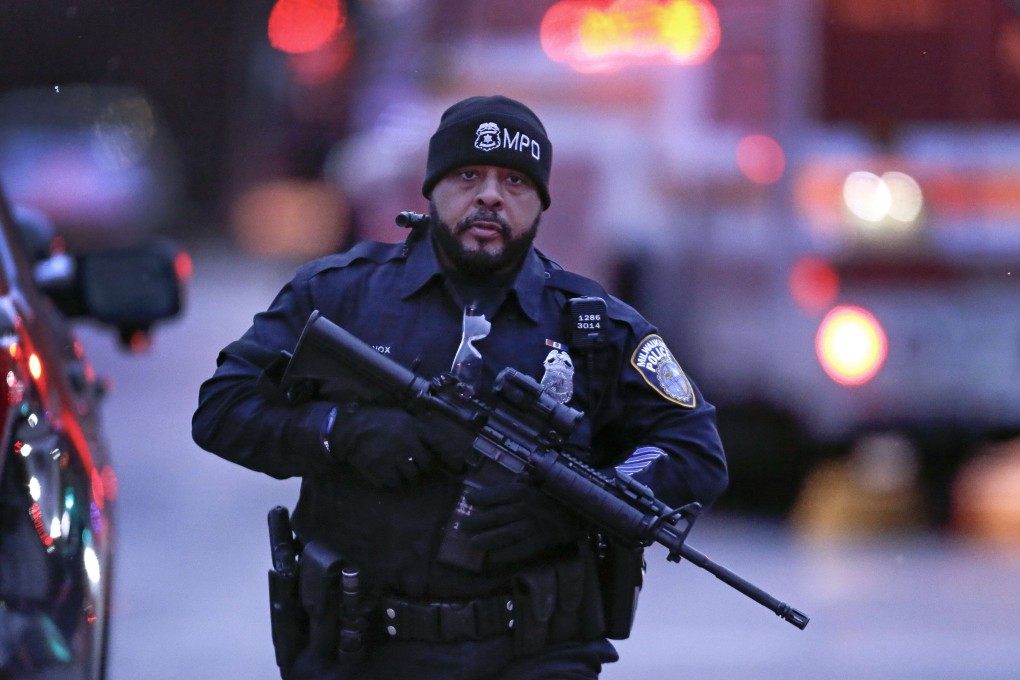 A US police officer works at a crime scene of a shooting in Milwaukee in February . Photo: Getty Images/AFP