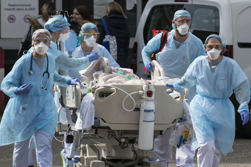 Medical staff in Mulhouse, where France first detected a spike in cases, transfer a patient to hospital. Photo: AFP