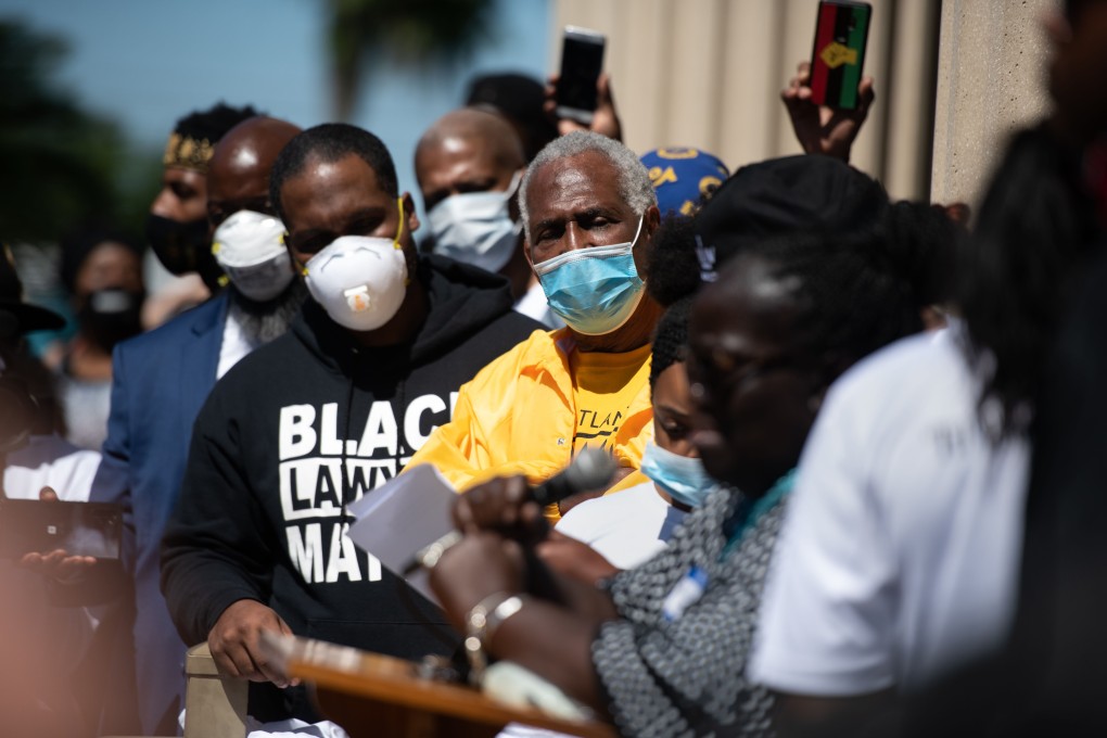 Demonstrators listen to a speaker during a protest of the shooting death of Ahmaud Arbery at the Glynn County Courthouse. Photo: AFP
