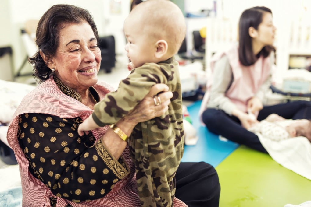 Purviz Shroff takes a baby in her arms at teen pregnancy charity Mother’s Choice in Mid-Levels, Hong Kong. She has helped launched the new “Our Hong Kong Family” initiative to encourage the community to help with a huge rise in demand for the charity’s services. Photo: Purviz Shroff
