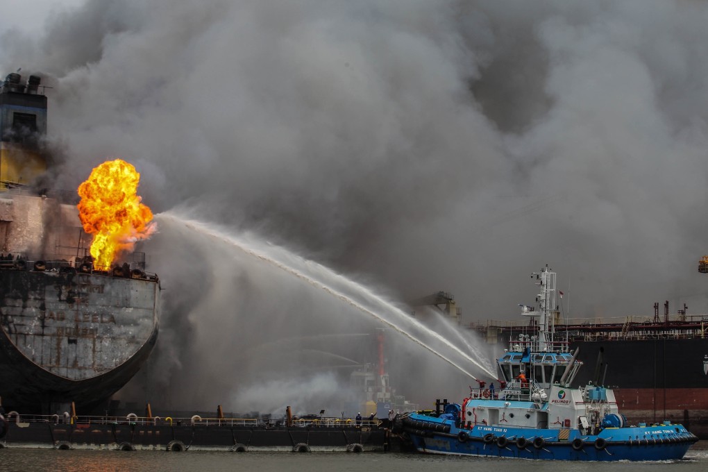 Firefighters try to extinguish a fire on a tanker ship docked in Belawan on May 11, 2020. Photo: AFP
