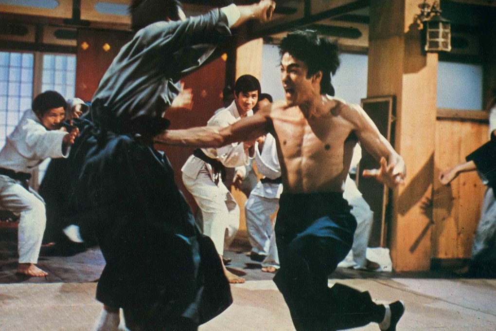 Bruce Lee in a still from Enter the Dragon, his most famous film that also featured Jackie Chan as a stuntman and extra.