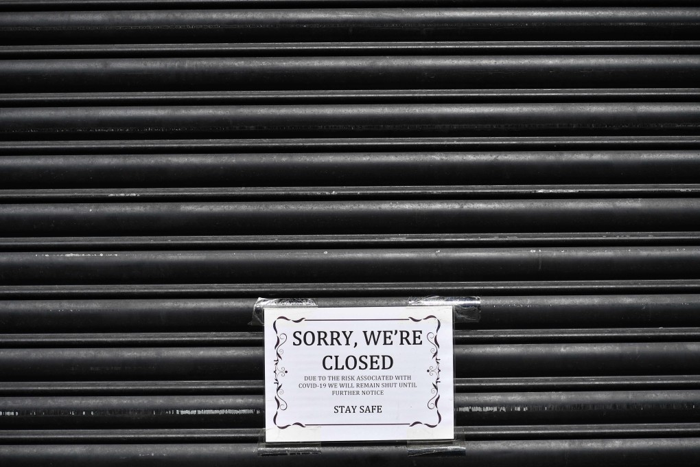 A sign informs customers that a shop in east London is closed during Britain’s nationwide lockdown. Photo: AFP
