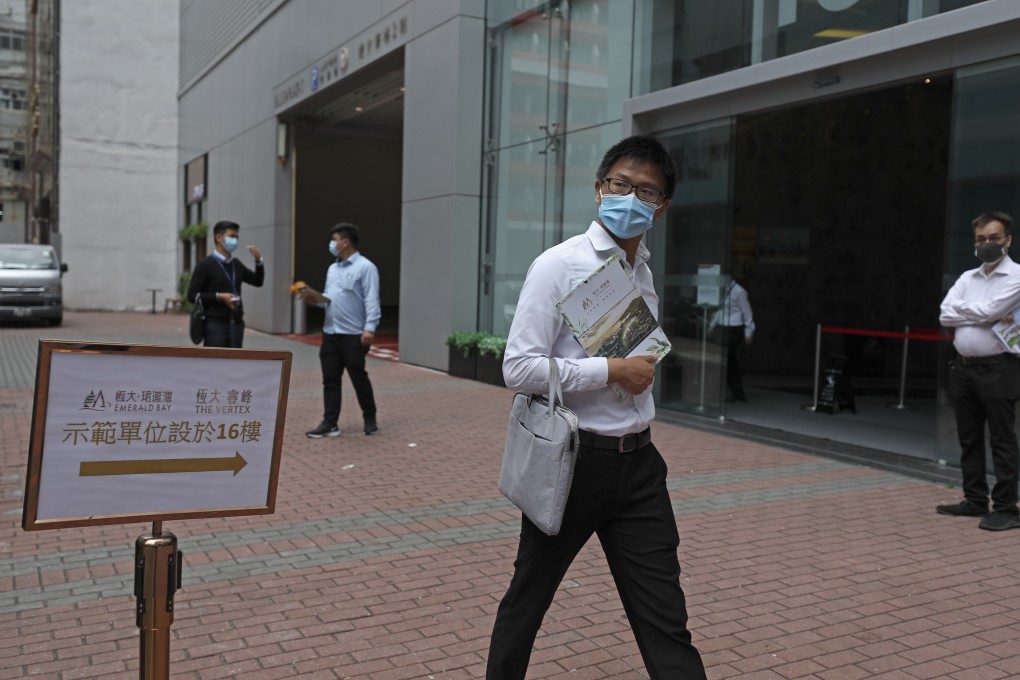 A real property agent approaches pedestrians near Billion Plaza, hoping to sell Emerald Bay flat units in Tuen Mun, Hong Kong on May 9. Photo: Xiaomei Chen