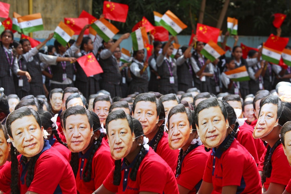 Students in Chennai, India, wear masks of China’s President Xi Jinping as others wave the national flags of India and China, ahead of his informal summit with Indian Prime Minister Narendra Modi, on October 10 last year. Photo: Reuters