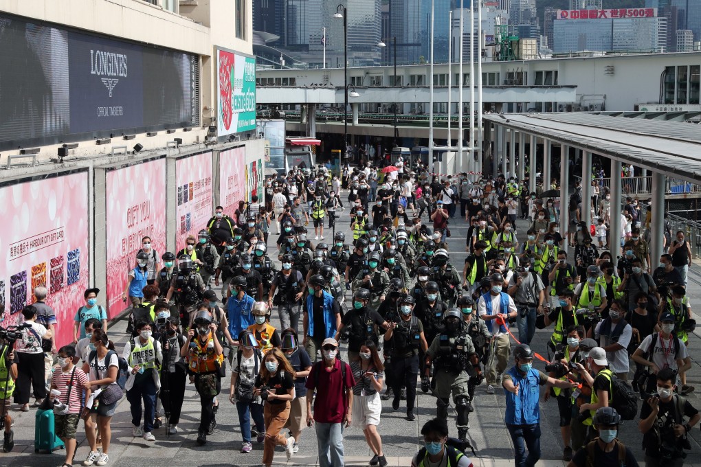Riot police march towards Harbour City in Tsim Sha Tsui on Sunday. Photo: Sam Tsang