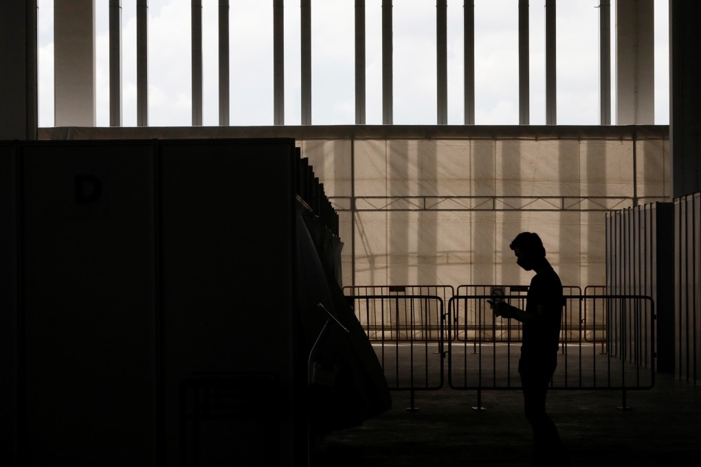 A man walks by in a new medical facility set up by the Singapore government to test migrant workers for Covid-19, on May 10. Photo: Reuters