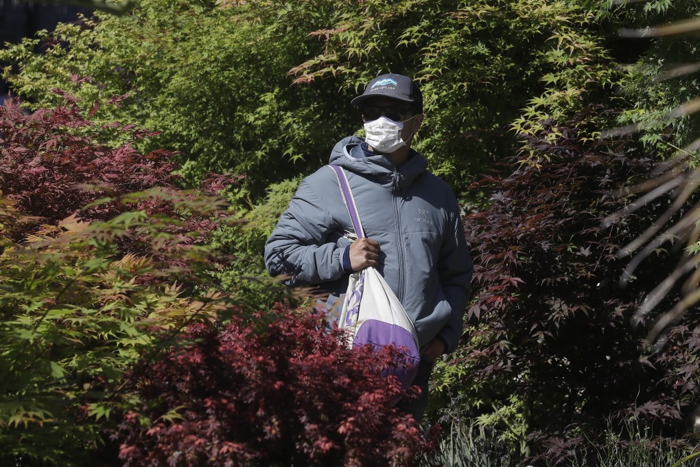 A shopper at the Flora Grubb Gardens in San Francisco on Saturday, after California loosened its stay-at-home orders, allowing some retailers to reopen. Many states are easing restrictions, which is causing coronavirus projections across the US to spike. Photo: AP