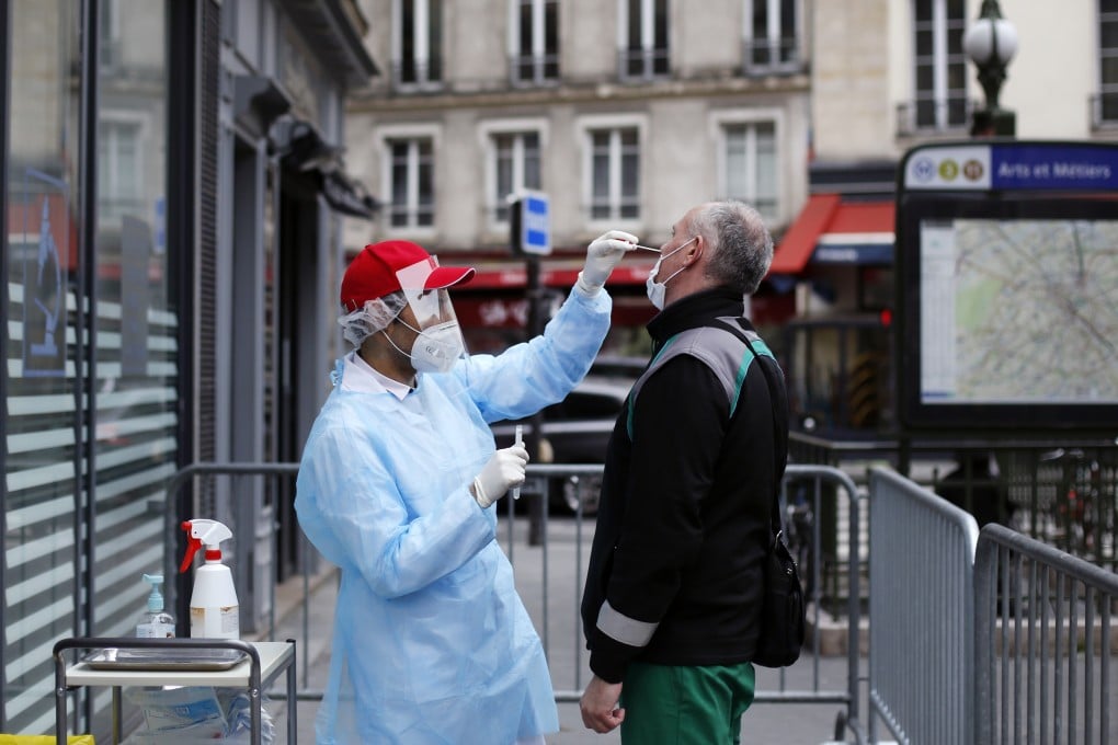 A health worker collects a nasal swab sample from a man to test for the coronavirus in Paris, as France cautiously eases its two-month lockdown. Photo: AP