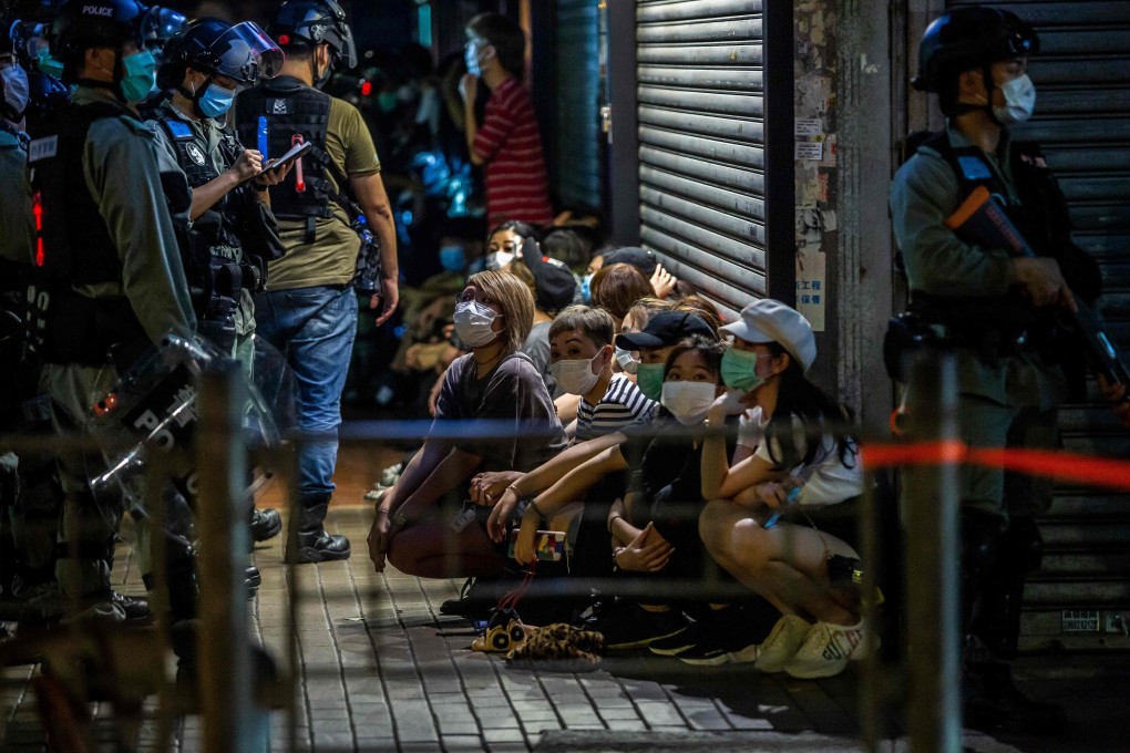 Police detain a group of people during protests on May 10 in Hong Kong. Photo: AFP