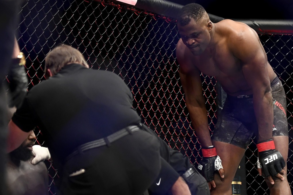Francis Ngannou looks on as Jairzinho Rozenstruik receives attention after their heavyweight fight at UFC 249. Photo: AFP