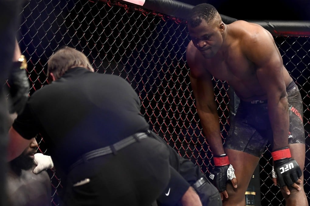 Francis Ngannou looks on as Jairzinho Rozenstruik receives attention after their heavyweight fight at UFC 249. Photo: AFP