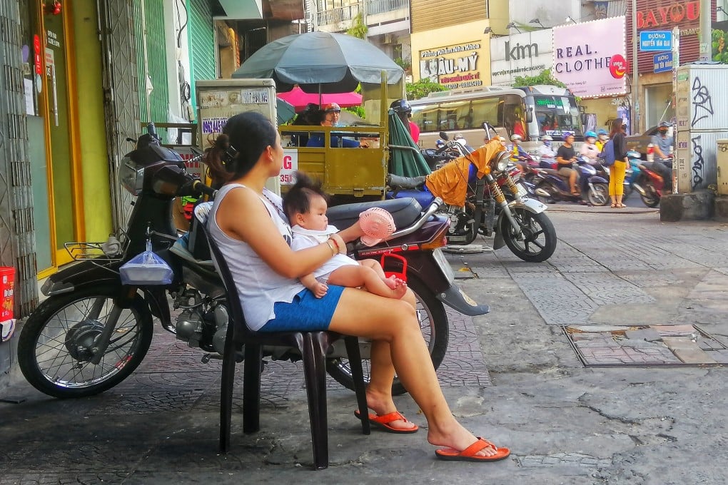 A Vietnamese woman and an infant in Ho Chi Minh City. Photo: Sen Nguyen