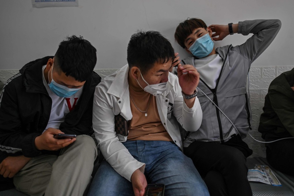 Men wait in an employment agency in Shanghai on April 28. Photo: AFP