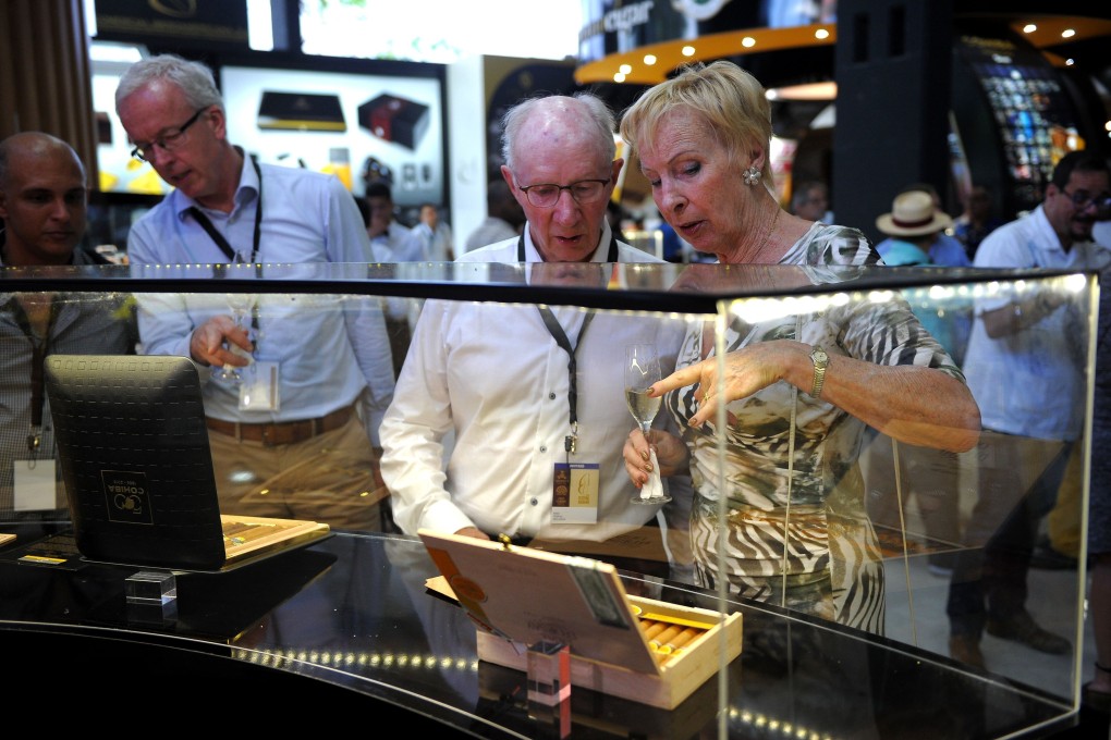 Delegates to the XIX Havana Cigar Festival look at a box of cigars at the Convention Palace in Havana, Cuba in 2017: Photo: Agence France-Presse