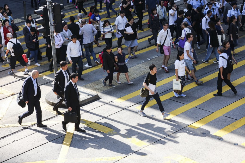 Bankers and workers from other sectors are slowly returning to work in Hong Kong as social distancing measures to contain the coronavirus outbreak are relaxed. Photo: Felix Wong