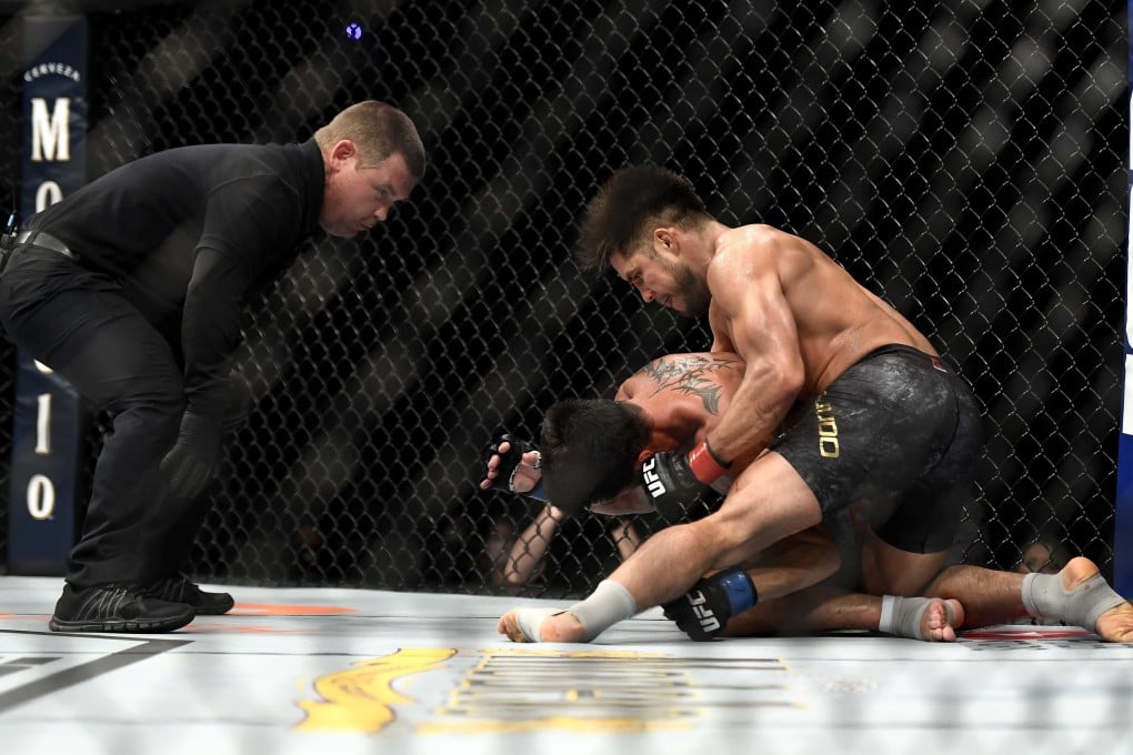 Henry Cejudo punches Dominick Cruz on the ground before referee Keith Peterson steps in at UFC 249. Photo: AFP