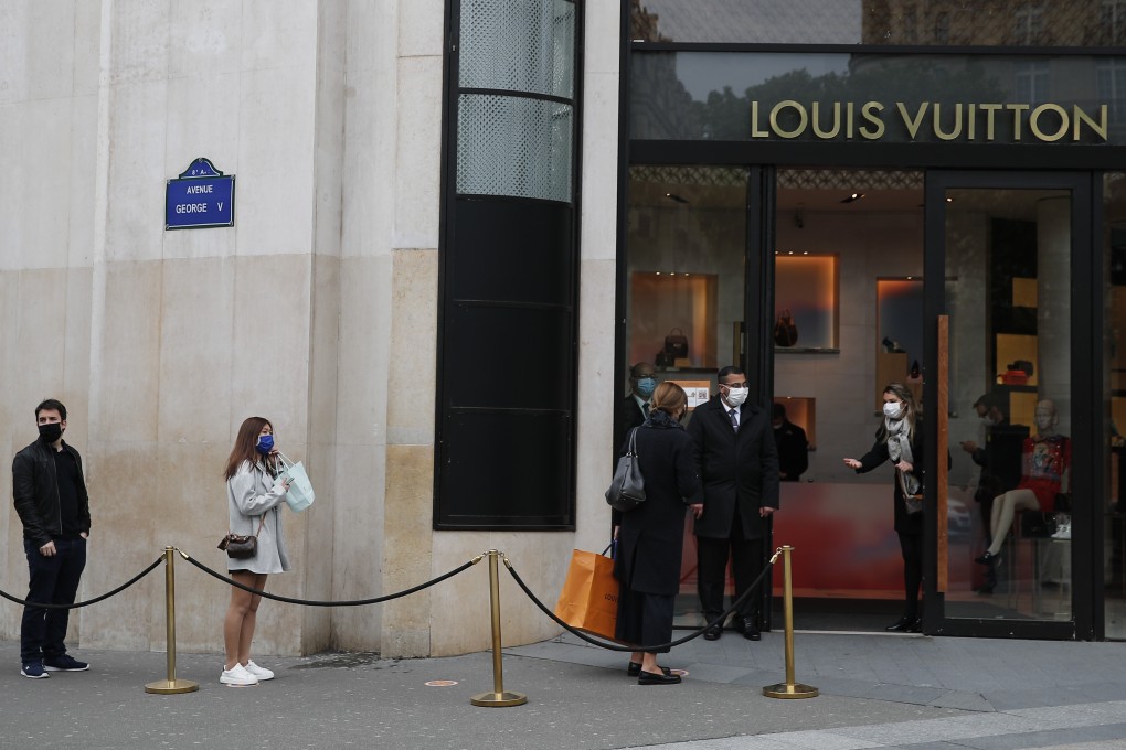 Shoppers, using social distancing, wait in line to enter a Louis Vuitton shop in Paris, France. The French began leaving their homes and apartments for the first time in two months as the country cautiously lifted its lockdown restrictions. Photo: AP