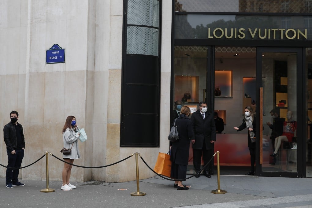 Shoppers, using social distancing, wait in line to enter a Louis Vuitton shop in Paris, France. The French began leaving their homes and apartments for the first time in two months as the country cautiously lifted its lockdown restrictions. Photo: AP