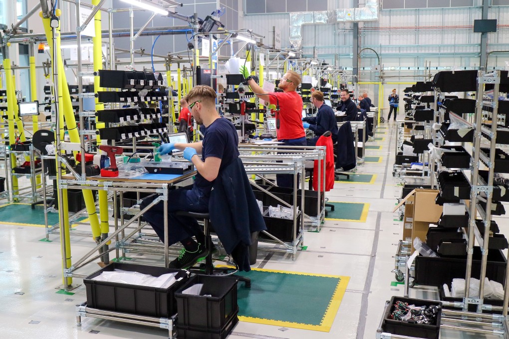 Employees work on a ventilator production line in an adapted hangar at an Airbus SE assembly plant in Broughton, Britain, on April 30. Industrial giants like Airbus are lending their factory floors to meet government orders. Photo: Bloomberg