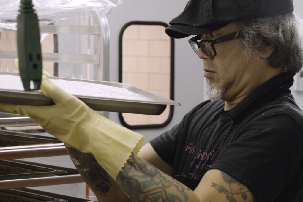 Paul Eng inspects a batch of rice cakes at Fong On. Photo: Eric Jenkins-Sahlin