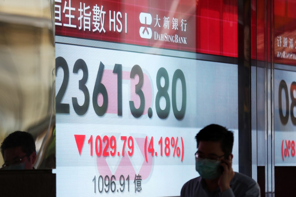 A person walks past a stock quotation board showing the Hang Seng Index in Hong Kong on May 4, 2020. Photo: Xinhua