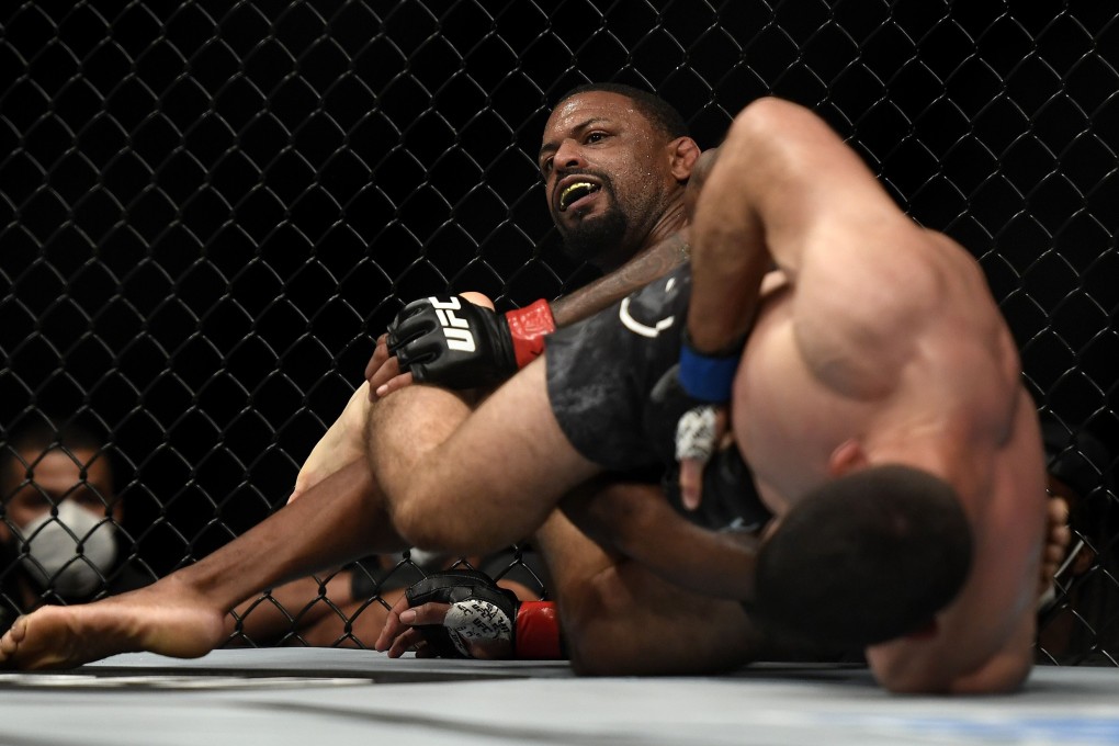 Thiago Moises applies a leg lock to Michael Johnson at UFC Fight Night. Photo: AFP