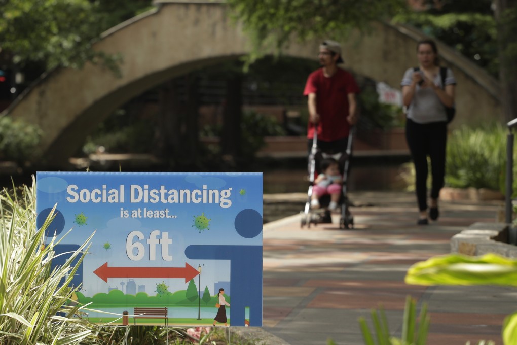 Signs encouraging social distancing pepper the River Walk in San Antonio, Texas. Photo: AP