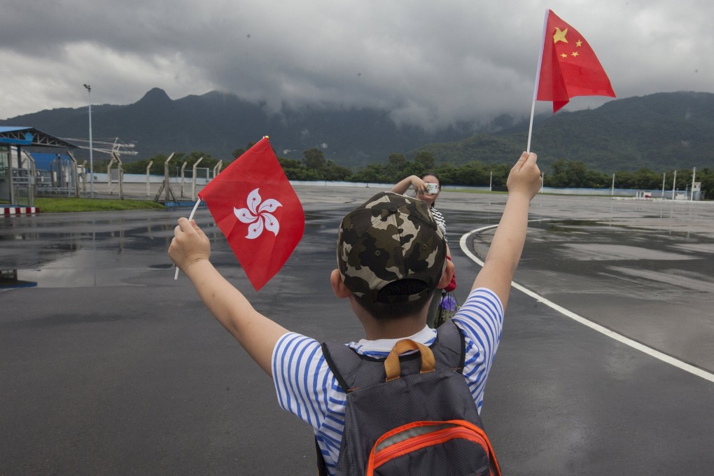 A child waves Hong Kong and Chinese flags at the People’s Liberation Army’s Shek Kong Barracks in Hong Kong on July 8, 2017. The PLA open day was part of celebrations to mark 20 years since the 1997 handover of Hong Kong’s sovereignty from Britain to China. Photo: EPA