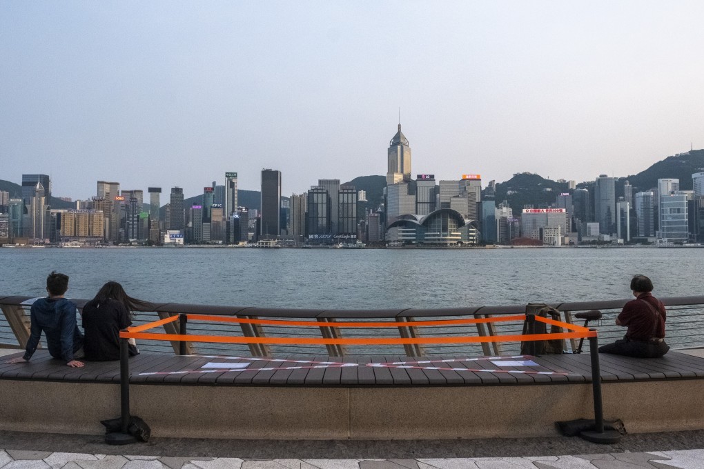 Visitors to the Tsim Sha Tsui promenade enjoy views of the Hong Kong Island skyline while following social distancing measures put in place because of a coronavirus outbreak, on April 17. Photo: Sun Yeung