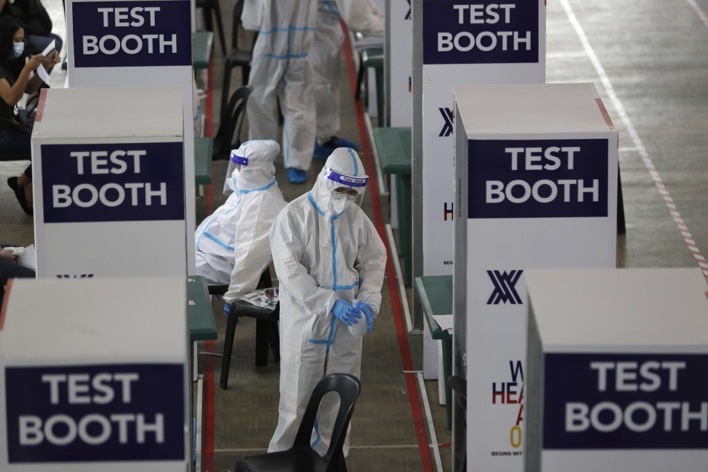 Health workers wait at a Covid-19 testing centre at the Palacio de Manila in the Philippines on Monday. Photo: AP