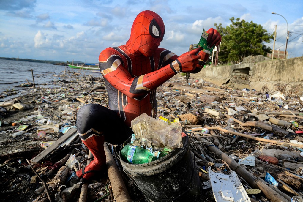 A man dressed in a Spider-Man costume picks plastic rubbish off a beach in Pare-Pare, in Indonesia’s South Sulawesi province, on January 18. Photo: Reuters