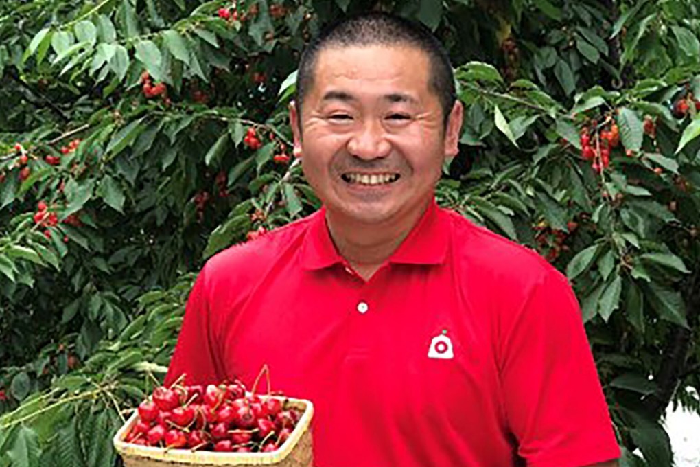 Yoshitomo Yahagi, president of Yamagata Sakuranbo Farm, poses with a basket of cherries. Photo: Twitter