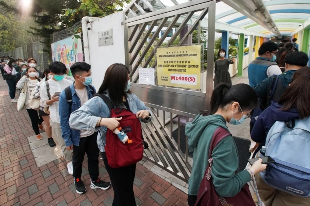 Hong Kong students sitting the Diploma of Secondary Education exam wait to be shown to their seats at a secondary school in Tsuen Wan on April 27. Photo: Felix Wong