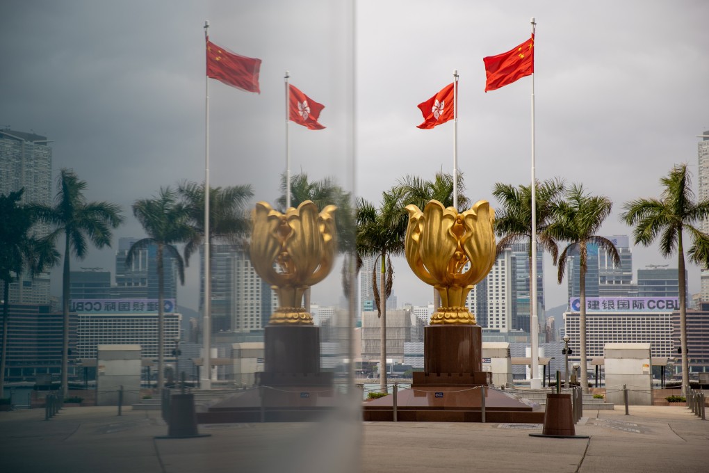 The Chinese and Hong Kong flags flutter above the Golden Bauhinia statue in Wan Chai, Hong Kong. Photo: EPA-EFE