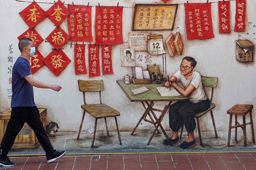 A man walks past a mural in Chinatown in Singapore. The city state is promoting its own distinctive cultural identity even as it capitalises on its shared cultural heritage to further ties with China. Photo: AFP